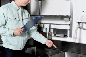 Asian,male,worker,checking,the,kitchen,sink