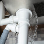 Close Up,of,water,is,leaking,from,the,white,sink,pipe